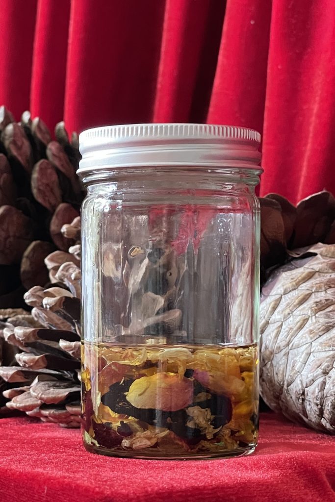 Glamour magic in a jar. A blend of herbs infusing in oil